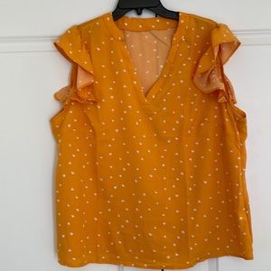 Pretty orange and white ruffle sleeved ladies top; like new